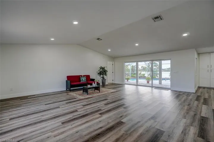 Living area featuring vaulted ceiling and light wood-type flooring