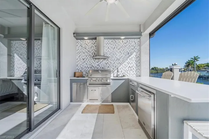 View of patio / terrace with area for grilling and ceiling fan