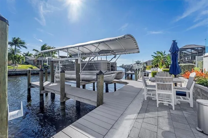 Dock area featuring a water view and boat lift