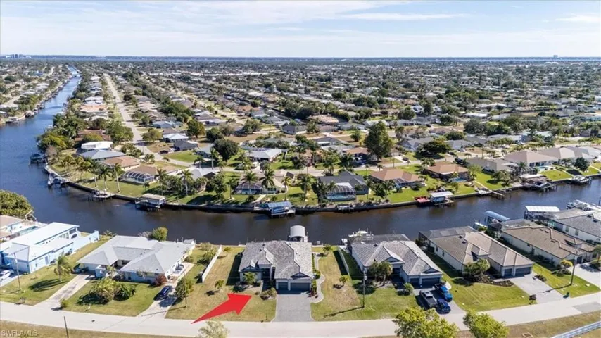 Aerial view of property's location featuring nearby suburban area