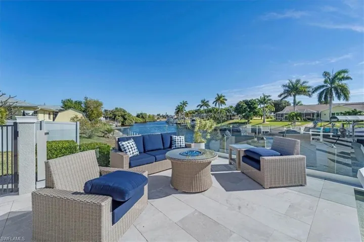 View of patio / terrace featuring an outdoor living space with a fire pit and a water view