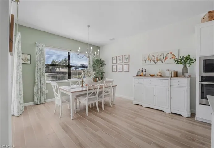 Dining space featuring a chandelier and light wood finished floors