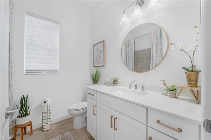 Bathroom with vanity and wood finish floors