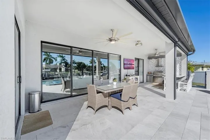 View of patio / terrace with outdoor dining area, ceiling fan, and exterior kitchen