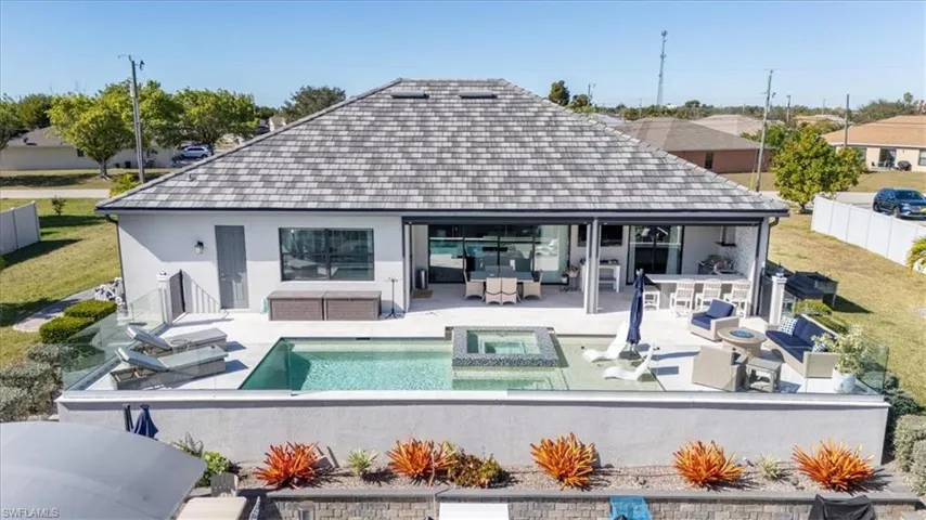 Back of property featuring outdoor lounge area, a fenced backyard, a patio, outdoor dining space, and stucco siding