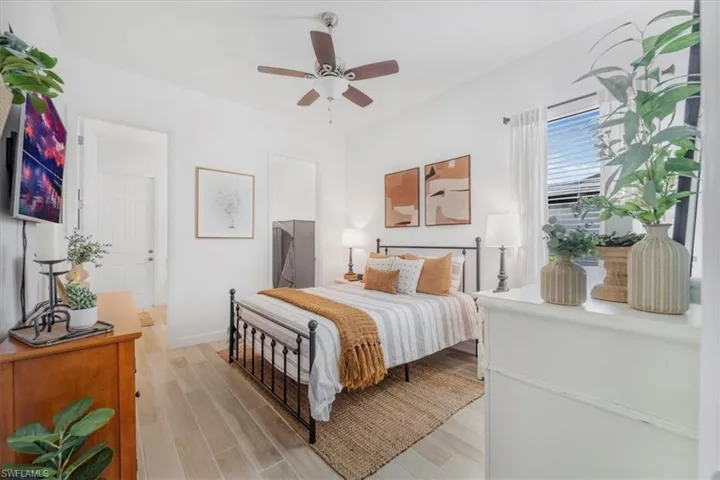 Bedroom with light wood-style flooring and a ceiling fan