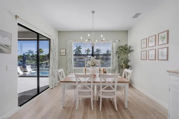 Dining area with wood finish floors and a chandelier