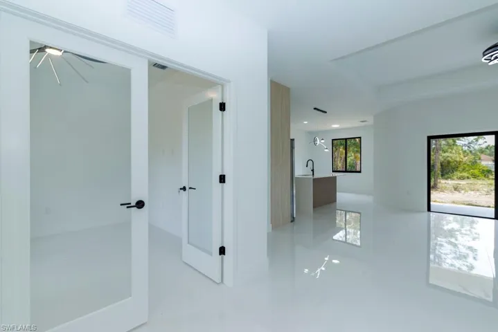 Hall featuring a sink and visible vents