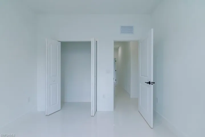 Unfurnished bedroom with baseboards, visible vents, and tile patterned flooring