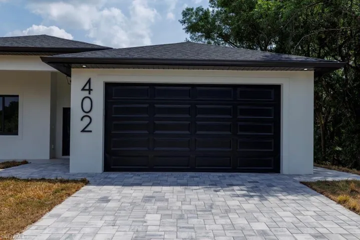 Garage featuring decorative driveway