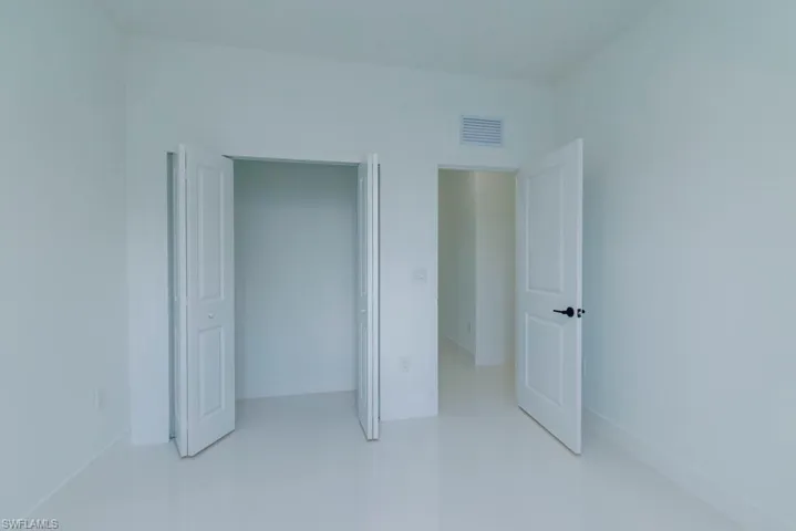 Unfurnished bedroom with baseboards and visible vents