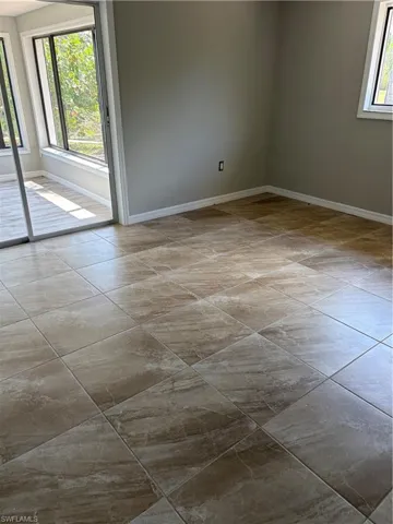 Spacious room featuring neutral wall paint and a large window