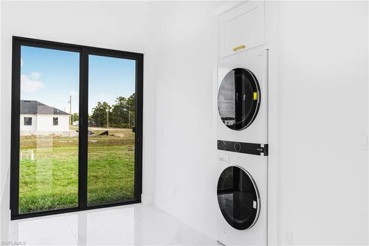 Laundry area with stacked washer / drying machine