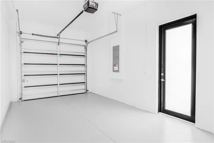 Garage with a garage door opener and electric panel
