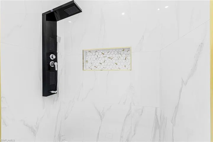 Room details with tiled shower