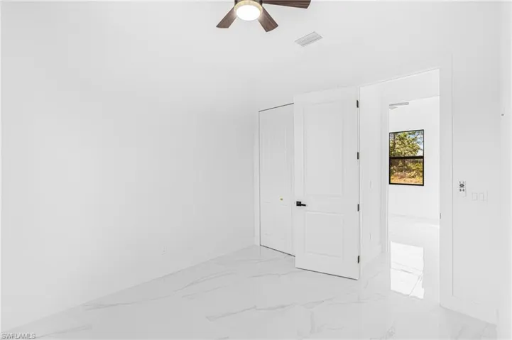Empty room featuring ceiling fan