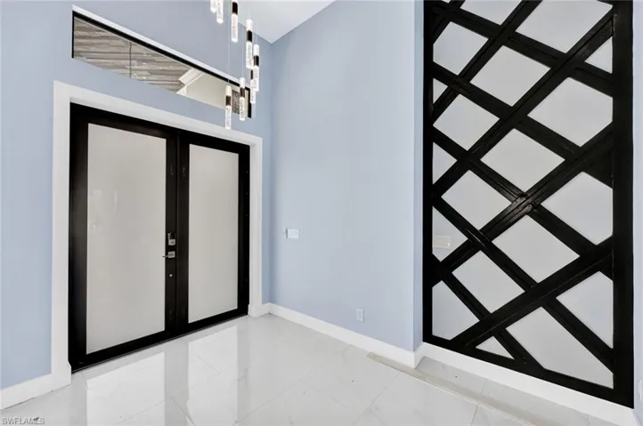 Foyer entrance with french doors and baseboards