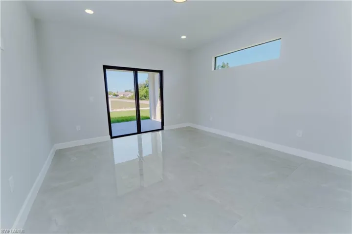 Empty room with a healthy amount of sunlight, baseboards, and recessed lighting
