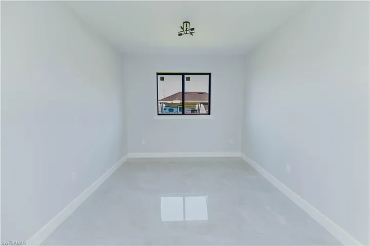 Empty room with baseboards and a healthy amount of sunlight