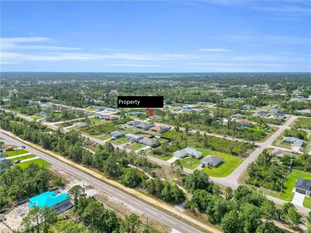 Aerial overview of property's location featuring nearby suburban area