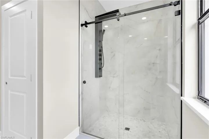 Bathroom featuring a marble finish shower