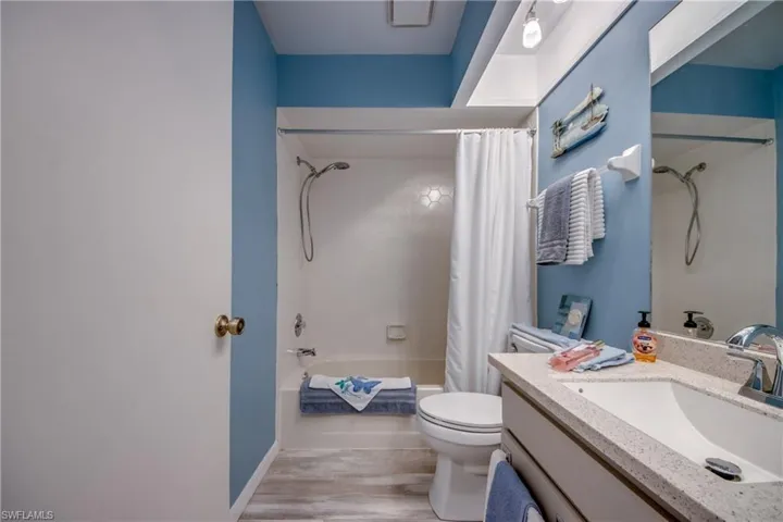 GUEST BATH WITH NEW VANITY TOP + SINK + COMMODE AND FLOORING.