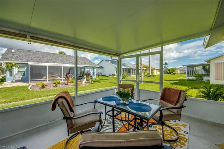 SCREENED LANAI WITH DOUBLE SCREEN DOORS FOR EASE OF MOVING LARGE OBJECTS.