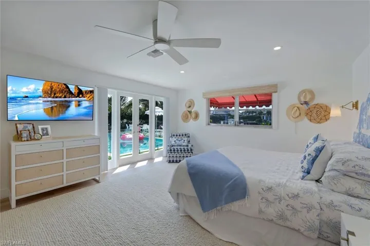 Bedroom featuring ceiling fan, french doors, and access to outside