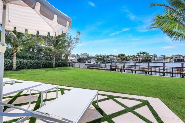 View of yard with a water view and a patio