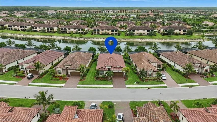 Aerial perspective of suburban area featuring a large body of water