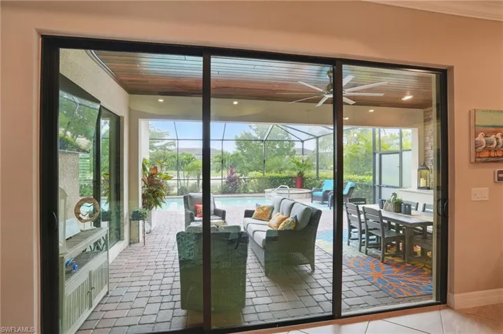 Entryway with a sunroom, a ceiling fan, healthy amount of natural light, and baseboards