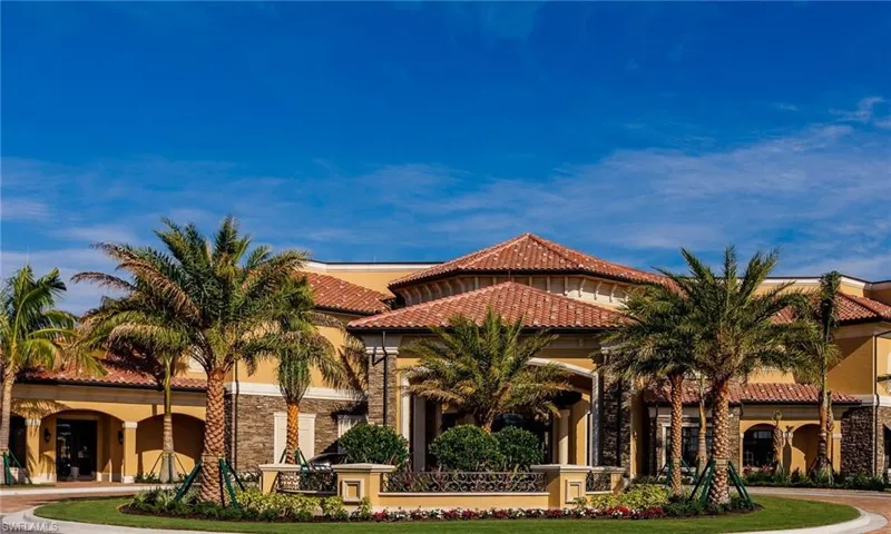 View of front of property with a tiled roof, stucco siding, and stone siding