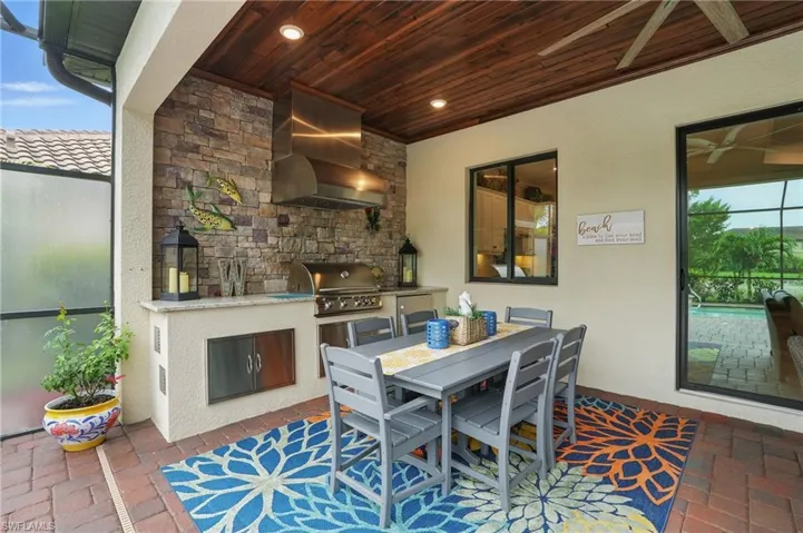 Dining space featuring wood ceiling, brick flooring, and recessed lighting