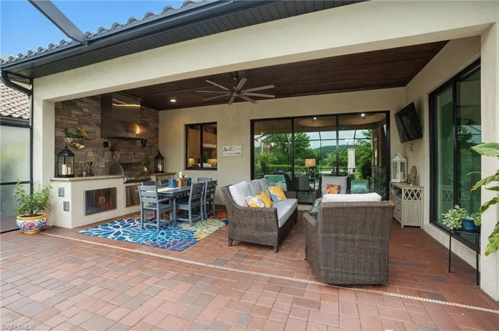 View of patio featuring a ceiling fan, outdoor dining space, and an outdoor living space