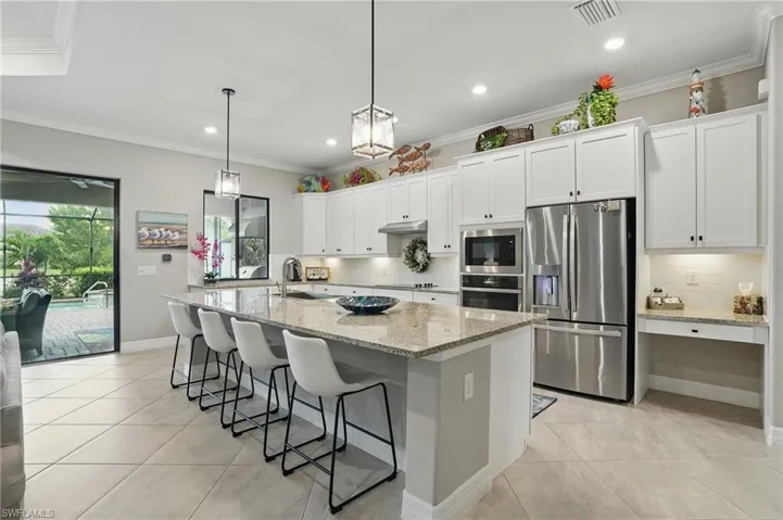 Kitchen featuring appliances with stainless steel finishes, a sink, light tile patterned floors, tasteful backsplash, and recessed lighting
