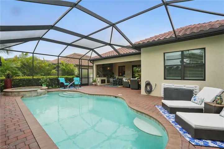 View of swimming pool featuring an outdoor living space, a patio area, a pool with connected hot tub, and a ceiling fan
