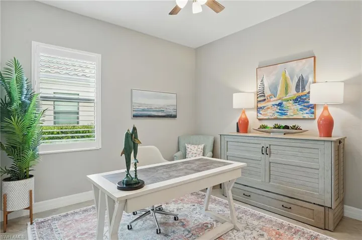 Office featuring ceiling fan, plenty of natural light, and baseboards