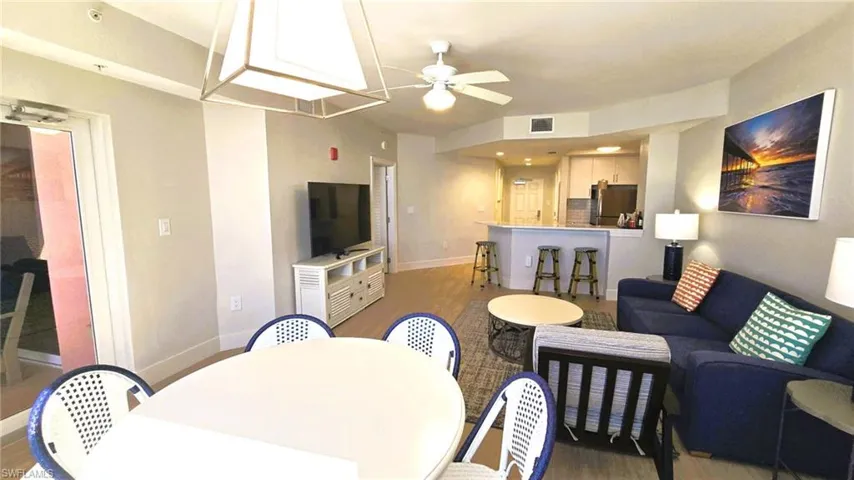 Living room featuring wood style finished floors and a ceiling fan