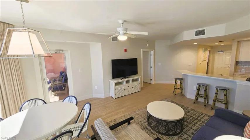 Living area with light wood finished floors, a ceiling fan, and recessed lighting