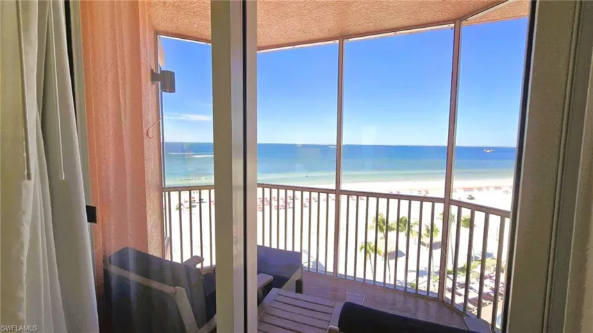 Balcony with view of water and beach