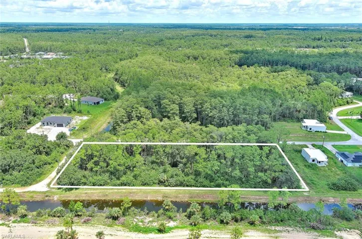 Aerial view of property's location featuring a forest and property boundaries highlighted