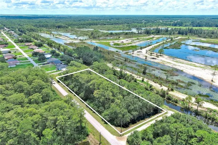 Aerial view of property's location with a nearby body of water and property boundaries highlighted