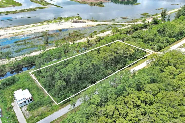Aerial overview of property's location with a large body of water and property boundaries highlighted