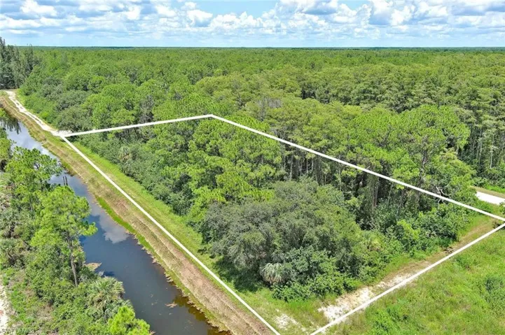 View of property location with property parcel outlined and a nearby body of water