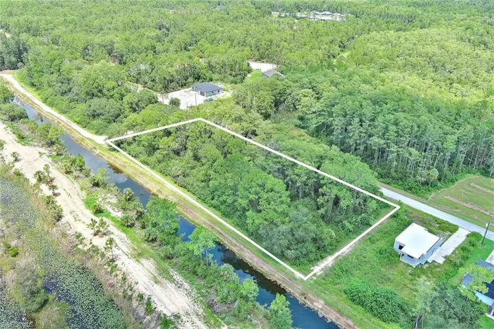 Aerial view of property's location featuring property parcel outlined and a large body of water