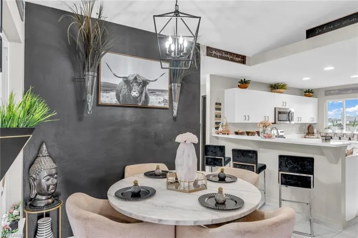 Dining room featuring a chandelier and light tile patterned floors