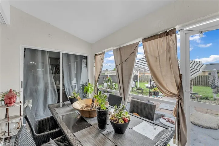 Sunroom / solarium featuring lofted ceiling