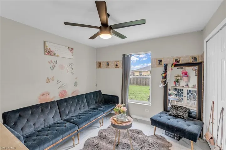 Tiled living room with ceiling fan