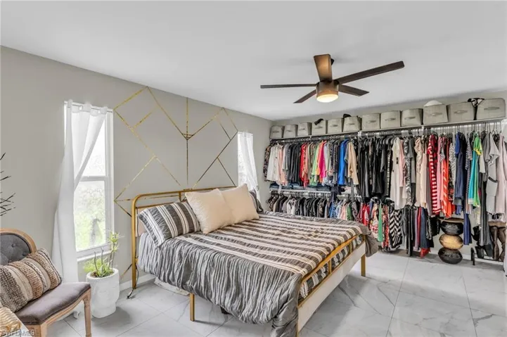 Bedroom featuring ceiling fan and tile patterned floors