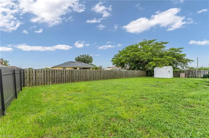 View of yard featuring a storage unit